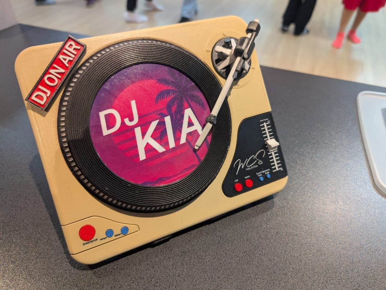 The DJ booth with a pink DJ KIA artwork record mounted on the platter