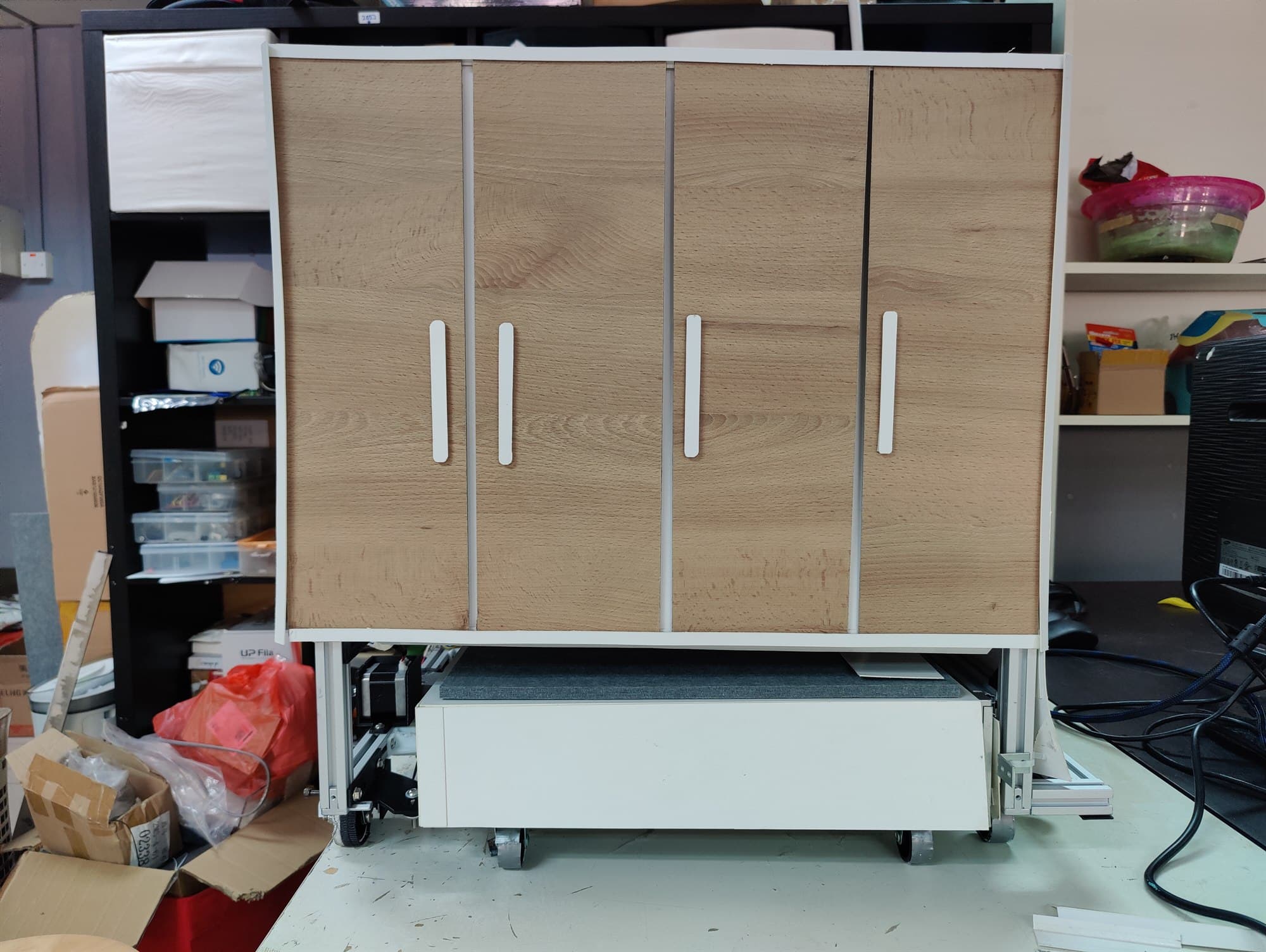 Movable furniture prototype — a cabinet on castors with a pull-out platform beneath it